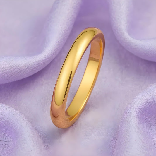 Gold ring on a soft purple fabric background